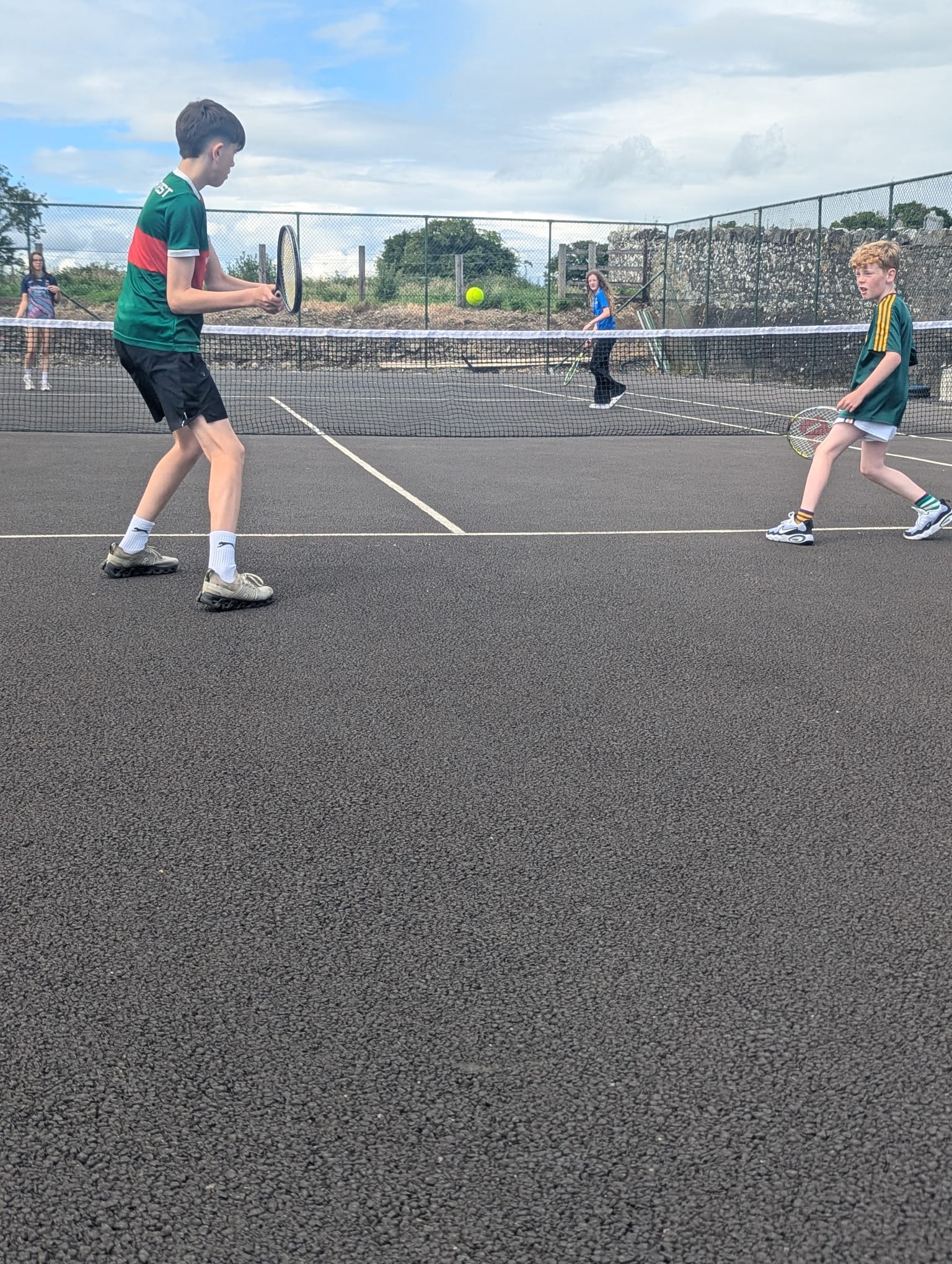 Juniors playing a doubles match on the court