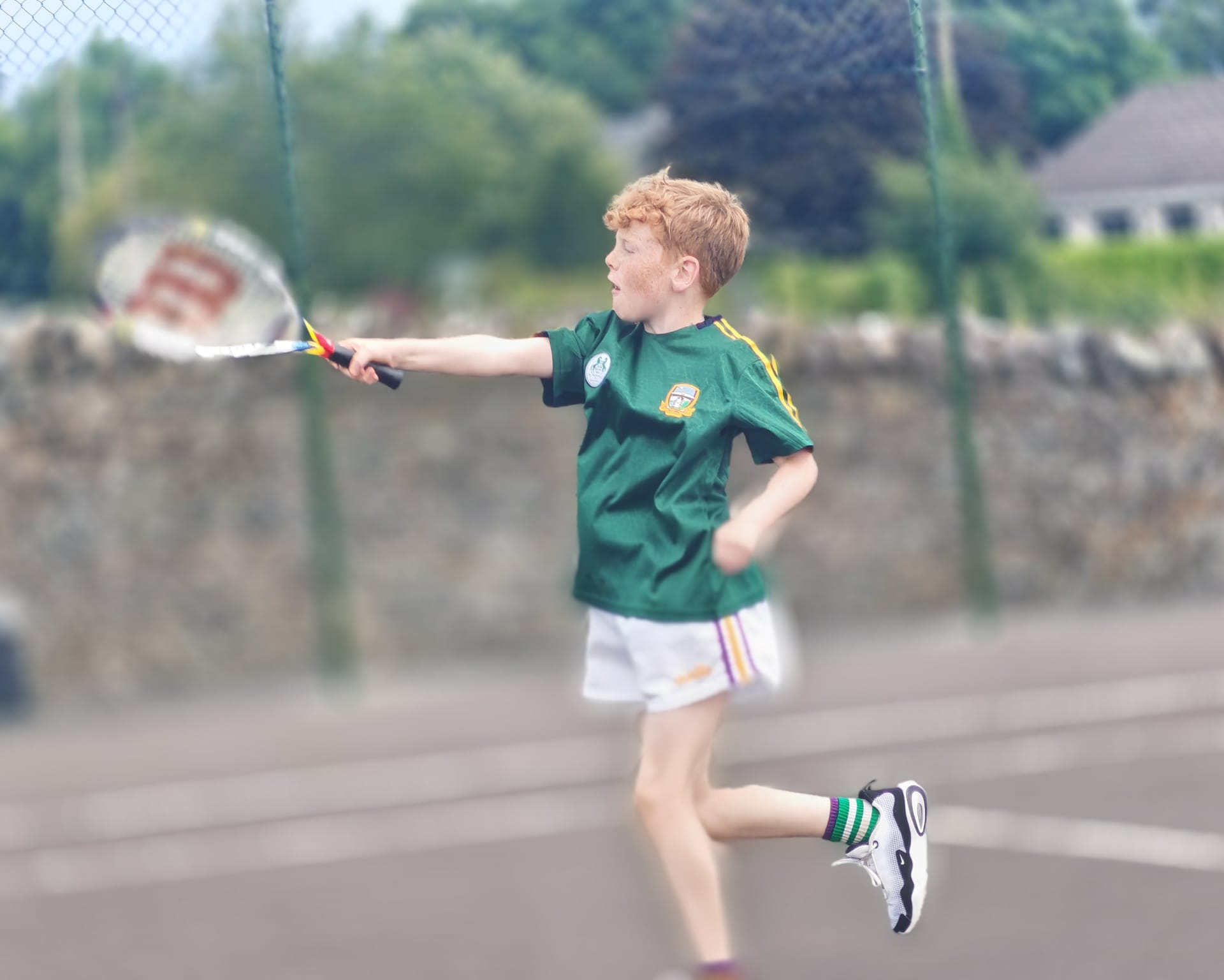 A junior player striking a forehand