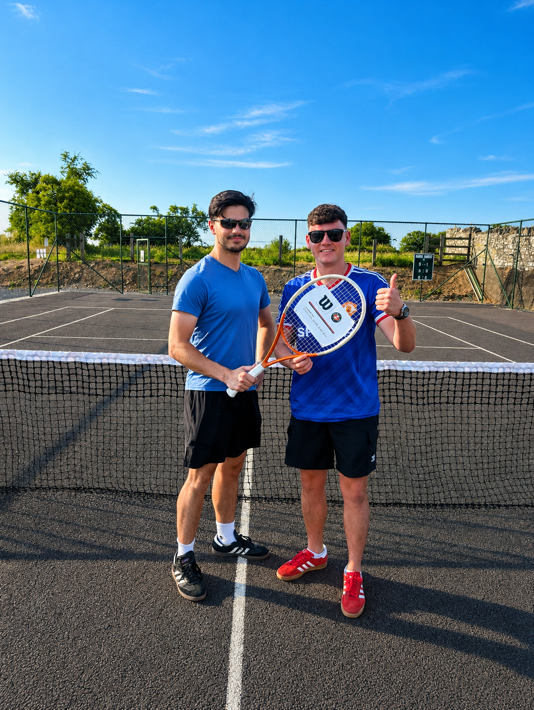 Two members at the net on a sunny day